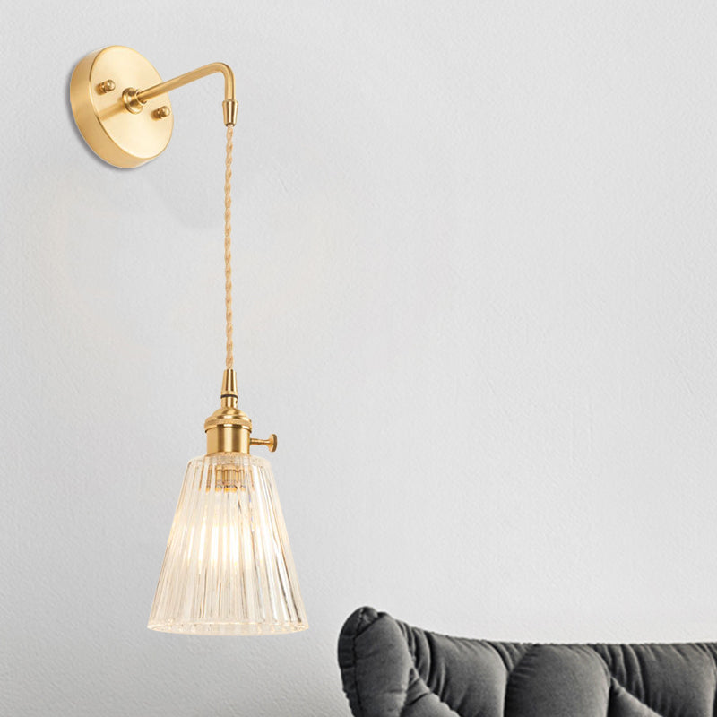 Sikunuo | A wall light with a bulb and conical shade made of clear, textured glass, industrial bedroom wall light fixture