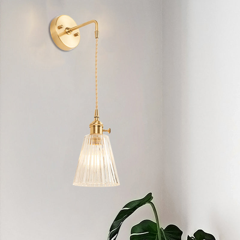Sikunuo | A wall light with a bulb and conical shade made of clear, textured glass, industrial bedroom wall light fixture