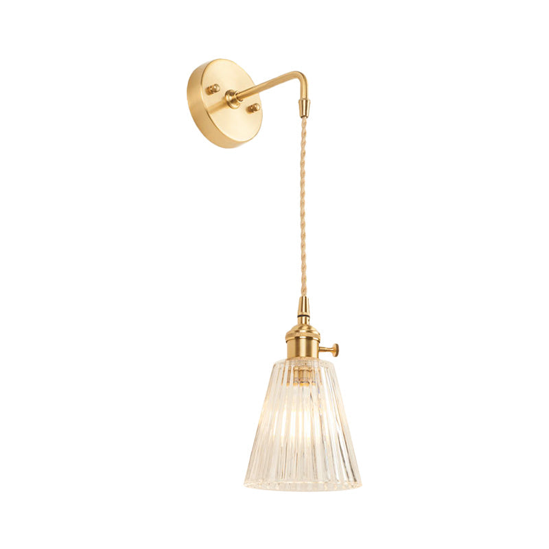 Sikunuo | A wall light with a bulb and conical shade made of clear, textured glass, industrial bedroom wall light fixture