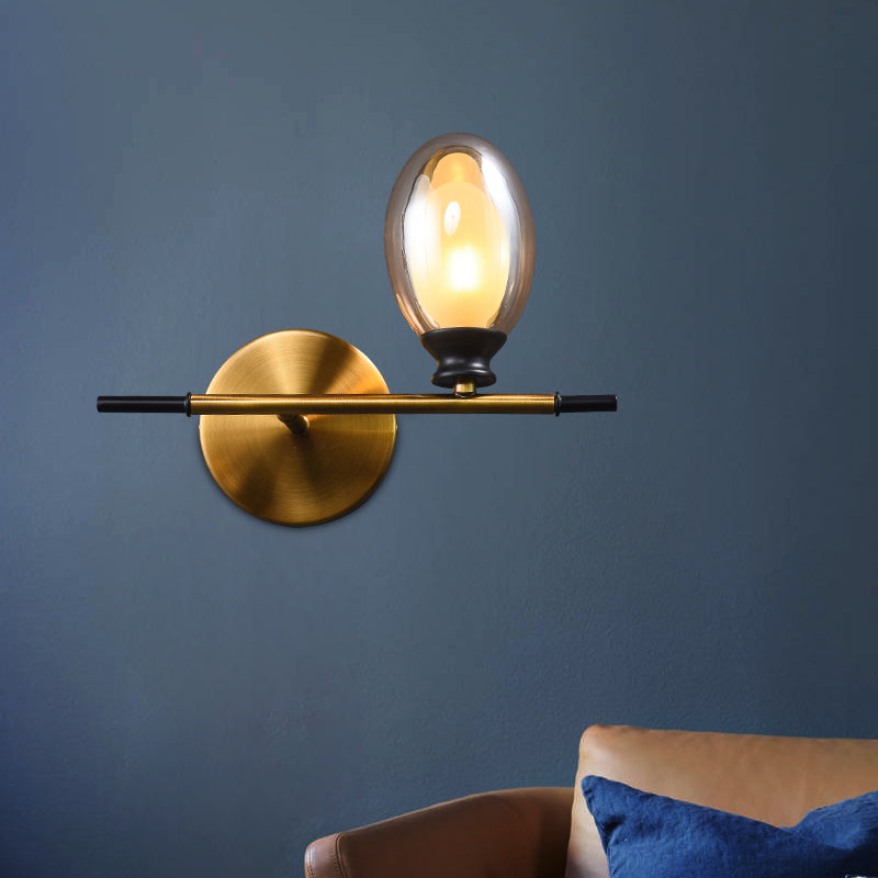 Sikunuo | Clear/Amber Glass Egg Shape Wall Light Minimalist 1 Light Brass Wall Lamp with Horizontal Arm