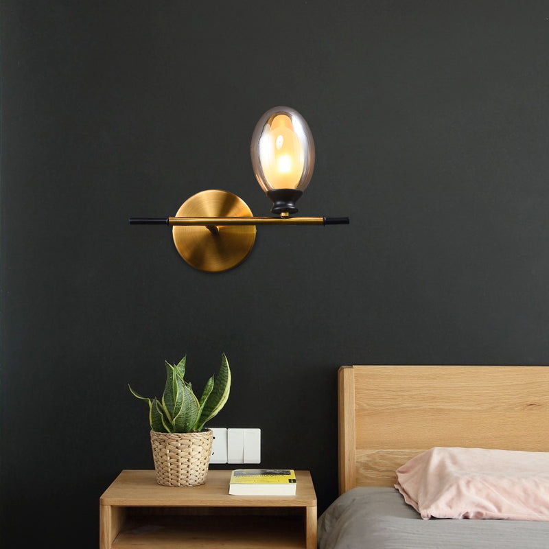 Sikunuo | Clear/Amber Glass Egg Shape Wall Light Minimalist 1 Light Brass Wall Lamp with Horizontal Arm
